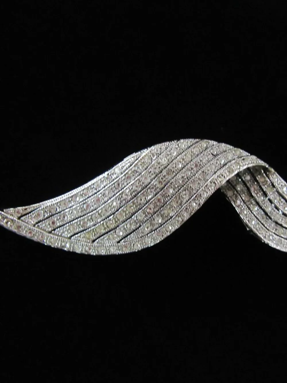 Clear pave rhinestone free form ribbon brooch in silver tone setting